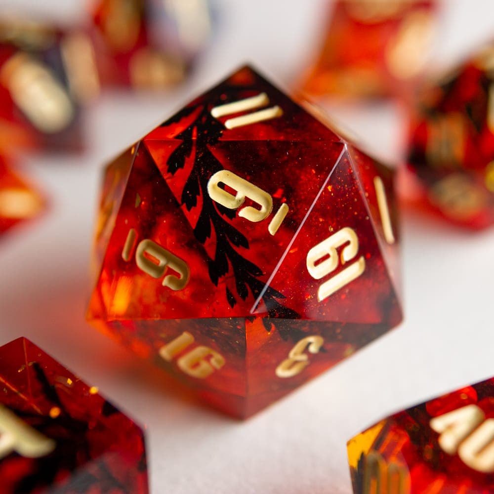 The Autumn Lights chonk: a red D20 with leaves cast inside and gold numbers