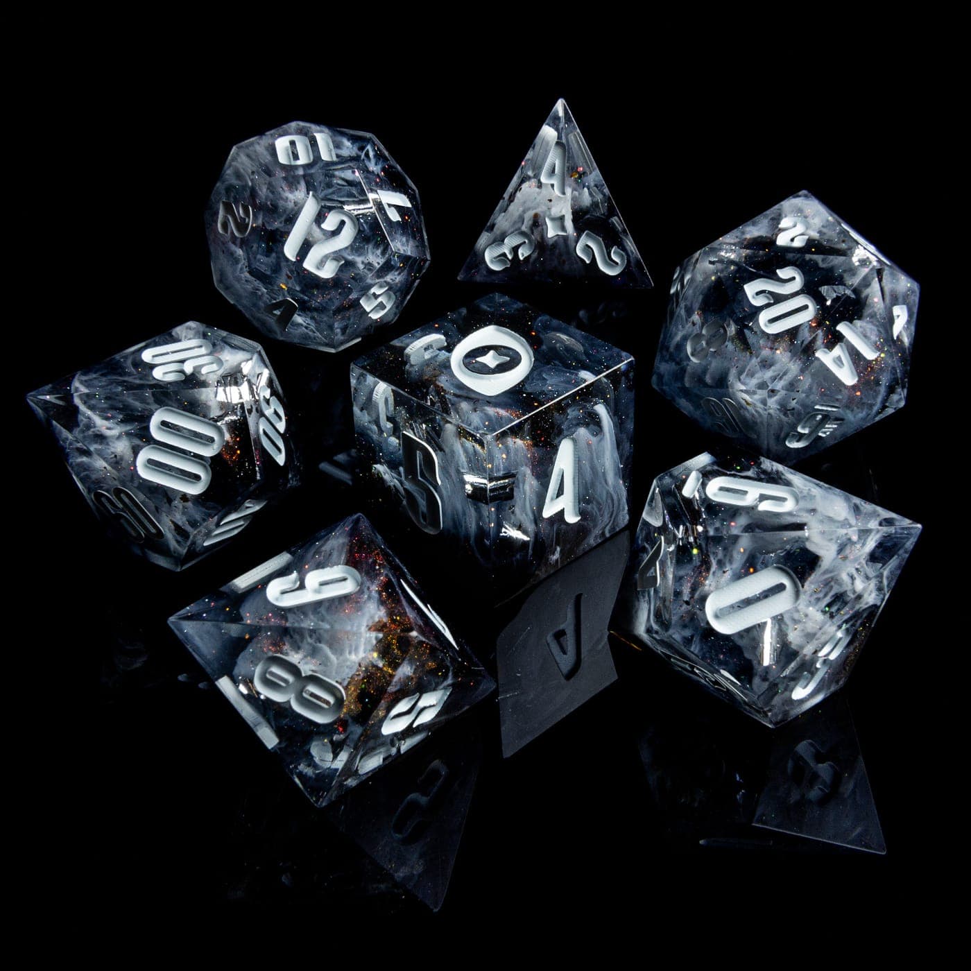 A clear resin seven-piece dice set with silver inked numbers on black